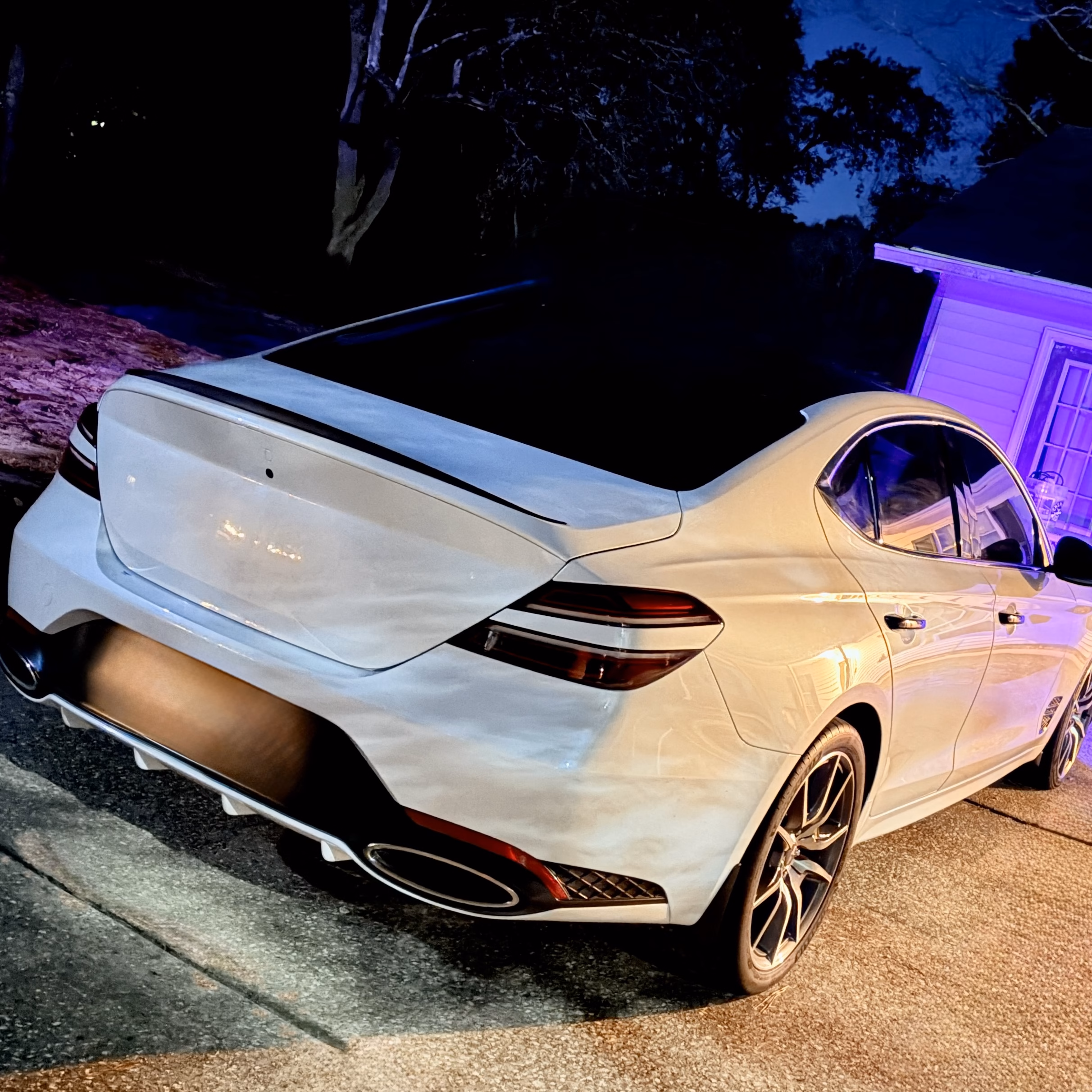 Genesis G70 with PLUGNPLAYCUSTOMS purple DRLs and spoiler